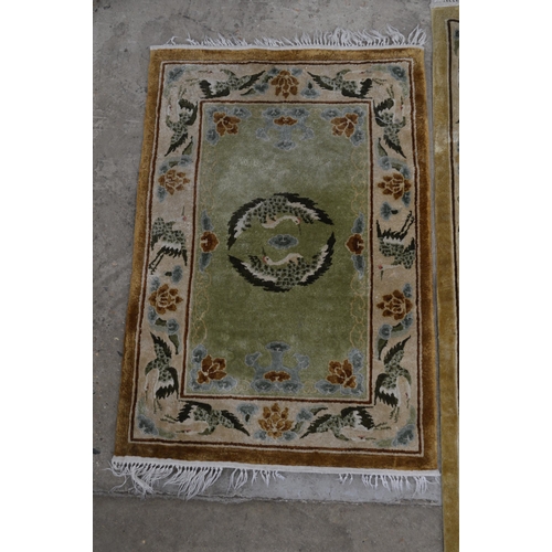 277 - Group of three patterned rugs all having a central panel and border decorated with storks and flower... 