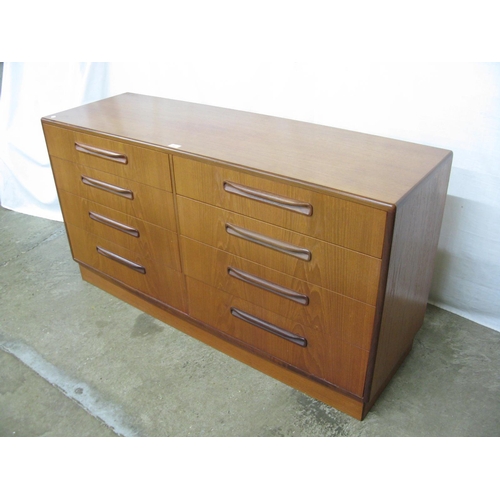 297 - G-Plan Fresco teak chest of eight graduated drawers with recessed handles, standing on a plinth base... 