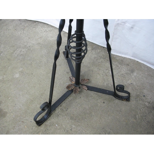 304 - Wrought iron telescopic oil lamp standard, standing on scrolled tripod base together with glass chim... 