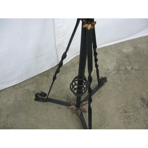 304 - Wrought iron telescopic oil lamp standard, standing on scrolled tripod base together with glass chim... 