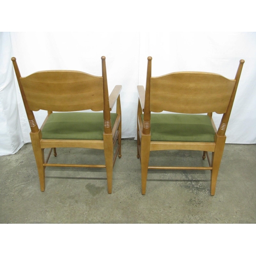 305 - Pair of modern beech elbow chairs having shaped backs and padded seats, standing on round tapering l... 