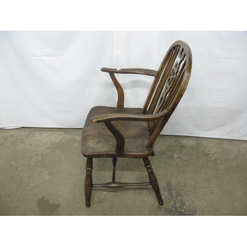 308 - Elm seated wheelback elbow chair having hoop back, standing on turned legs with stretchers - 57cm x ... 