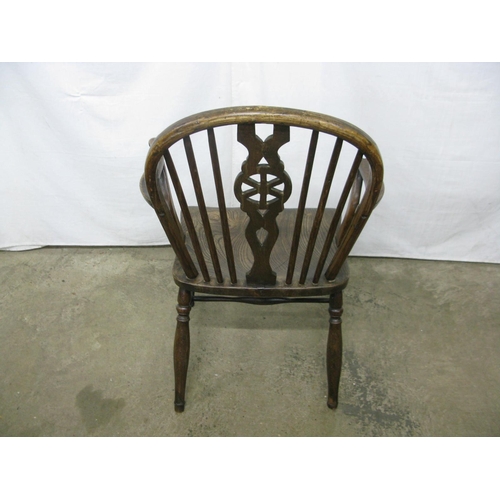 308 - Elm seated wheelback elbow chair having hoop back, standing on turned legs with stretchers - 57cm x ... 