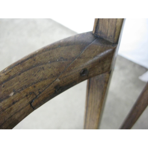 308 - Elm seated wheelback elbow chair having hoop back, standing on turned legs with stretchers - 57cm x ... 