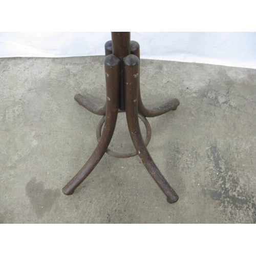 318 - Bentwood hat stand having a ring of six hooks over another ring of six hooks, standing on splayed su... 