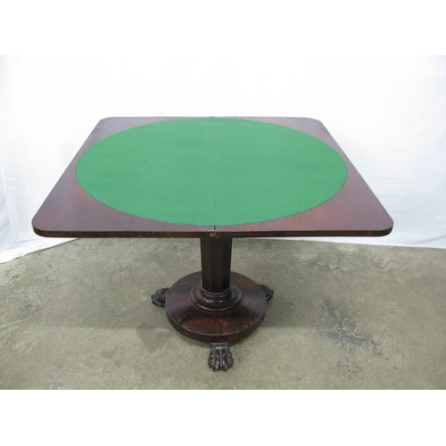 319 - Mahogany fold over card table, the top opening to a circular green baize, standing on an octagonal c... 