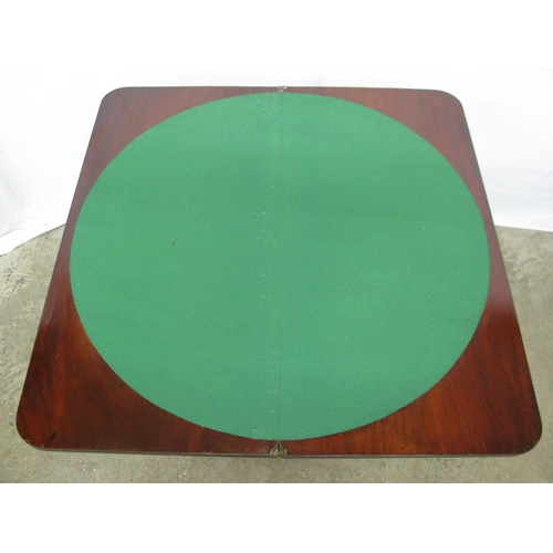 319 - Mahogany fold over card table, the top opening to a circular green baize, standing on an octagonal c... 