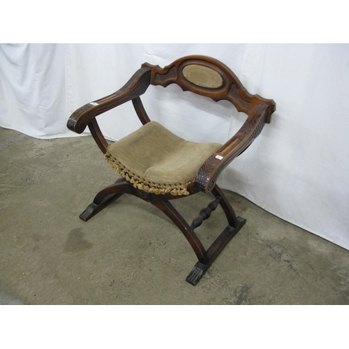 323 - Carved stained beech X frame chair having removable seat and carved arm terminals - 68cm x 50cm x 74... 