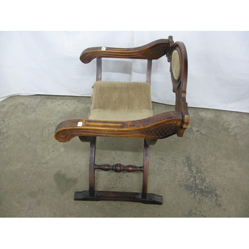 323 - Carved stained beech X frame chair having removable seat and carved arm terminals - 68cm x 50cm x 74... 