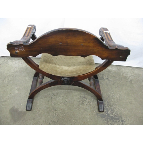 323 - Carved stained beech X frame chair having removable seat and carved arm terminals - 68cm x 50cm x 74... 