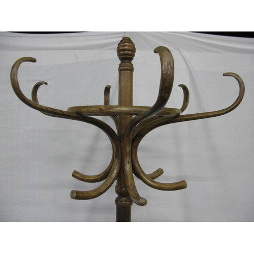 324 - Bentwood hat stand having six scrolled hooks over an umbrella stand, standing on splayed supports - ... 