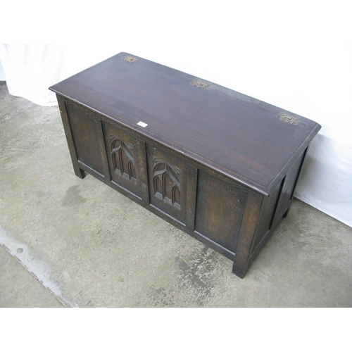 325 - Webber Furniture oak coffer, the hinged lift top lid opening to a storage space with two carved fron... 