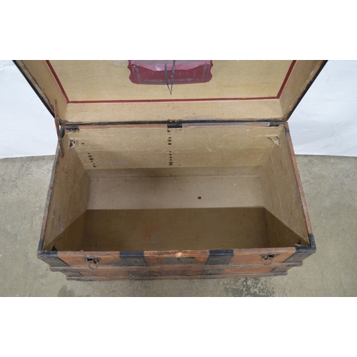 334 - Wooden metal bound dome top trunk, the hinged lift top lid opening to a canvas lined interior, stand... 