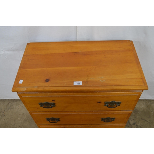 339 - Modern pine chest of three drawers, standing on a plinth base - 63cm x 34cm x 74cm tall (one handle ... 