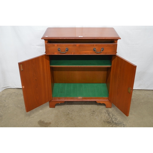 344 - Reproduction yew wood inlaid cross banded side cabinet having a single drawer over two doors opening... 