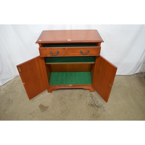 344 - Reproduction yew wood inlaid cross banded side cabinet having a single drawer over two doors opening... 