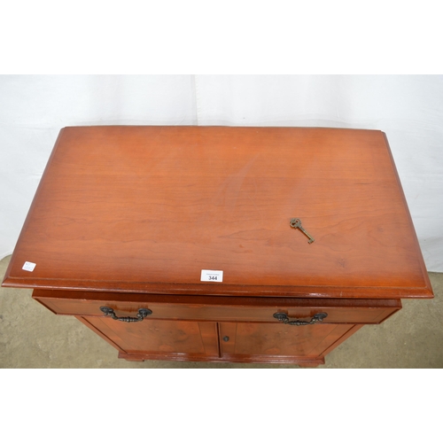 344 - Reproduction yew wood inlaid cross banded side cabinet having a single drawer over two doors opening... 