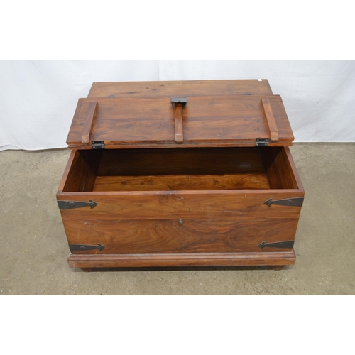 345 - Hardwood metal bound box base coffee table having two hinged lift top lids and iron carrying handles... 