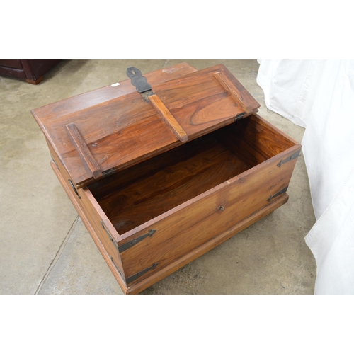 345 - Hardwood metal bound box base coffee table having two hinged lift top lids and iron carrying handles... 