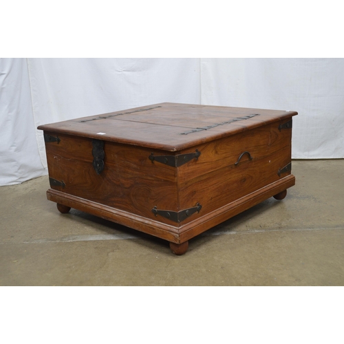 345 - Hardwood metal bound box base coffee table having two hinged lift top lids and iron carrying handles... 