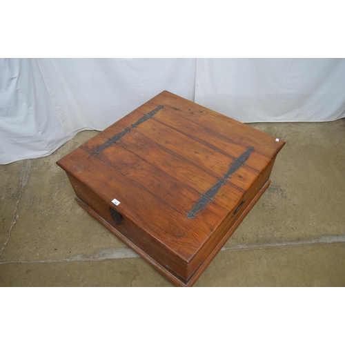 345 - Hardwood metal bound box base coffee table having two hinged lift top lids and iron carrying handles... 