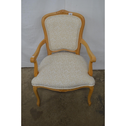 348 - Stuart Jones carved beech open armchair having padded back, seat and arm rests, standing on carved s... 