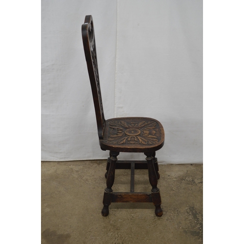 349 - Carved oak spinning chair having a pierced back with carved foliate decoration and carved seat, stan... 