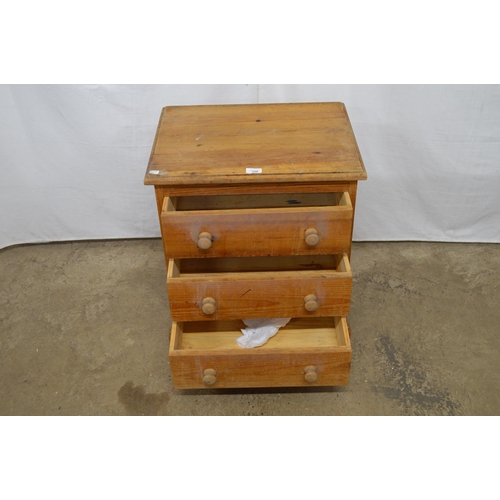 350 - Small pine chest of three drawers, standing on a shaped plinth base - 54cm x 41cm x 63cm tall (stain... 