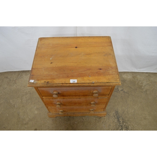 350 - Small pine chest of three drawers, standing on a shaped plinth base - 54cm x 41cm x 63cm tall (stain... 