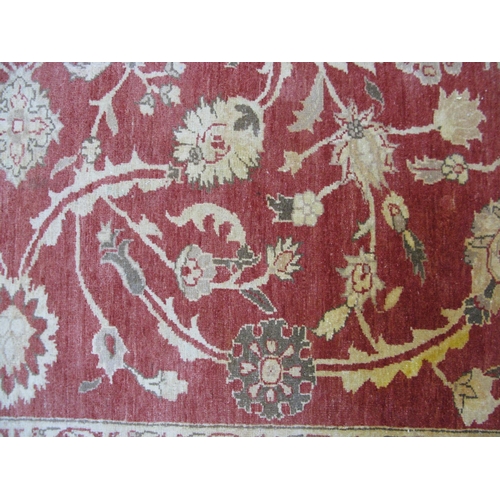 351 - Large red and pale orange ground patterned rug having a large central design surrounded by patterned... 