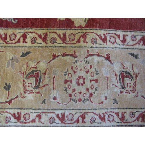 351 - Large red and pale orange ground patterned rug having a large central design surrounded by patterned... 