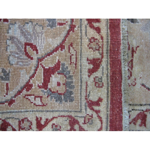 351 - Large red and pale orange ground patterned rug having a large central design surrounded by patterned... 