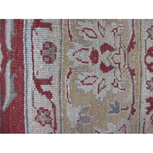 351 - Large red and pale orange ground patterned rug having a large central design surrounded by patterned... 