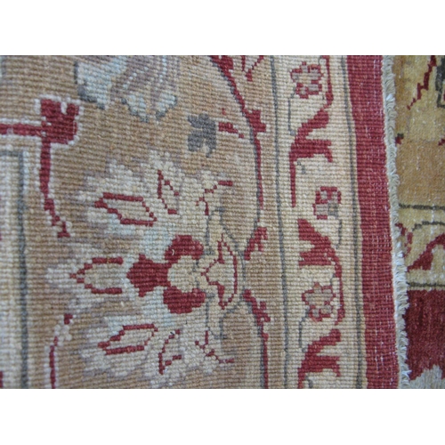 351 - Large red and pale orange ground patterned rug having a large central design surrounded by patterned... 