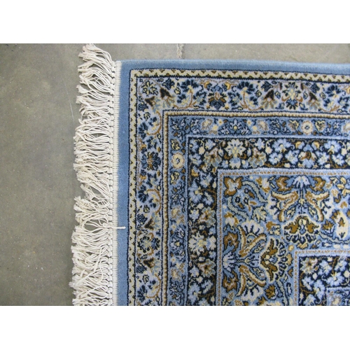 352 - Super Keshan blue ground patterned rug having a central lozenge with intricate floral and foliate de... 