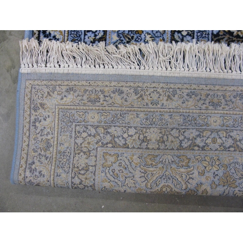 352 - Super Keshan blue ground patterned rug having a central lozenge with intricate floral and foliate de... 