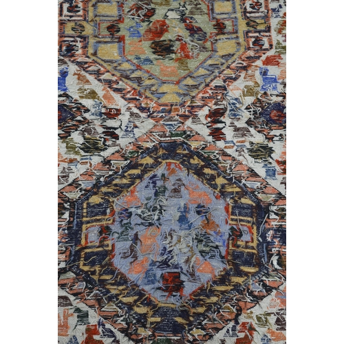 357 - Two near matching rugs, both having two central geometric lozenges filled and surrounded by animals ... 