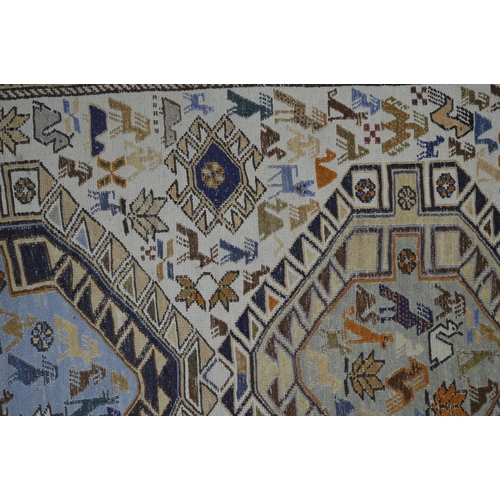 357 - Two near matching rugs, both having two central geometric lozenges filled and surrounded by animals ... 