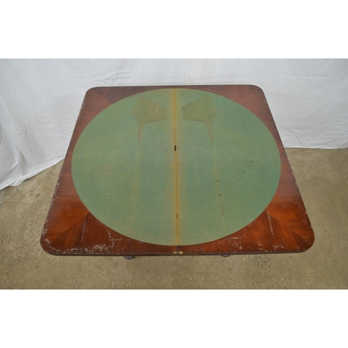 358 - Mahogany fold over card table the top opening to a circular green baize, standing on hexagonal colum... 