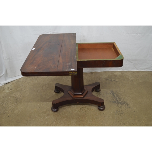 358 - Mahogany fold over card table the top opening to a circular green baize, standing on hexagonal colum... 