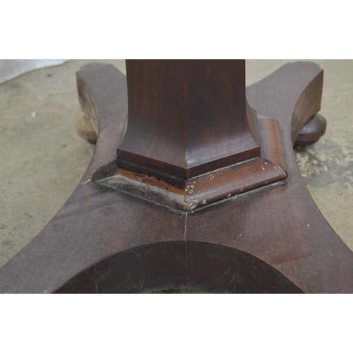 358 - Mahogany fold over card table the top opening to a circular green baize, standing on hexagonal colum... 