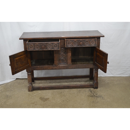 360 - Carved oak sideboard having two floral carved drawer fronts over two carved panelled door cupboard b... 