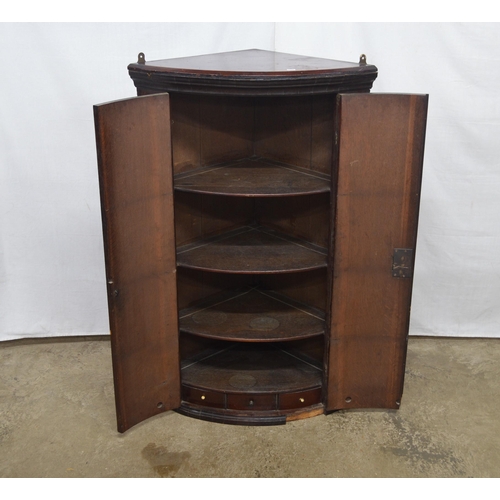 362 - Mahogany bow front corner wall cabinet, the two doors opening to three shelves over three small draw... 