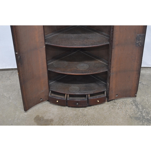 362 - Mahogany bow front corner wall cabinet, the two doors opening to three shelves over three small draw... 