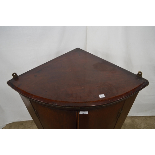 362 - Mahogany bow front corner wall cabinet, the two doors opening to three shelves over three small draw... 