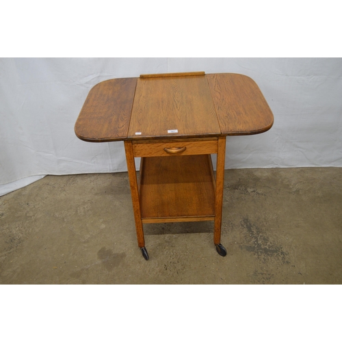 367 - Oak dropleaf tea trolley having a single drawer over a lower tier united by square supports on casto... 