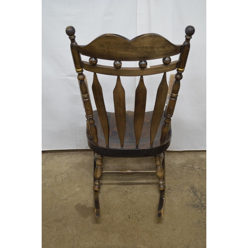 376 - Beech stained rocking chair having a gilt stencilled cresting rail, slat back and scrolled arms, sta... 