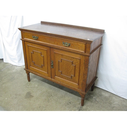 386 - Oak sideboard having raised back over a single long drawer with two panelled doors opening to a sing... 