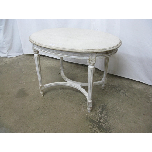 387 - Oval painted coffee table standing on fluted legs with X cross stretcher - 73cm x 52cm x 53cm tall