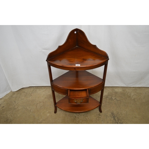 391 - Reproduction mahogany three tier corner washstand, the shaped raised back over a central tier with a... 